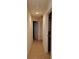 Hallway with light walls and tile floors, leading to bedrooms and bath at 332 David Walker Dr # J-2, Tavares, FL 32778