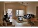 Bright living room with tile floors, a large window, and a comfortable couch at 332 David Walker Dr # J-2, Tavares, FL 32778