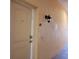 Exterior entryway to condo unit with light beige walls and light fixture at 332 David Walker Dr # J-2, Tavares, FL 32778