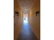 Well-lit hallway with light-colored walls and modern light fixtures at 332 David Walker Dr # J-2, Tavares, FL 32778