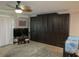 Living room with wall-mounted TV, built-in Murphy bed, and ample storage at 3700 S Atlantic Ave # 407, New Smyrna Beach, FL 32169