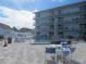 Refreshing community pool with plenty of lounge chairs at 3700 S Atlantic Ave # 407, New Smyrna Beach, FL 32169