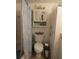 Bathroom with toilet, shower, and beach-themed decor at 3700 S Atlantic Ave # 407, New Smyrna Beach, FL 32169