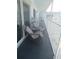 Balcony with two chairs and a small table at 3700 S Atlantic Ave # 407, New Smyrna Beach, FL 32169