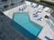 An overhead view of the community pool and surrounding patio at 3700 S Atlantic Ave # 407, New Smyrna Beach, FL 32169
