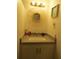 Bathroom vanity with a round mirror and various toiletries at 3700 S Atlantic Ave # 407, New Smyrna Beach, FL 32169