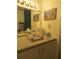 Bathroom vanity with beach art and various toiletries at 3700 S Atlantic Ave # 407, New Smyrna Beach, FL 32169
