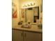 Bathroom vanity with flamingo art and various toiletries at 3700 S Atlantic Ave # 407, New Smyrna Beach, FL 32169