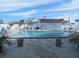 Community pool with lounge chairs and a patio area at 3700 S Atlantic Ave # 407, New Smyrna Beach, FL 32169