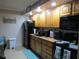 Modern kitchen boasting wood cabinets, black appliances, and granite countertops at 3700 S Atlantic Ave # 407, New Smyrna Beach, FL 32169