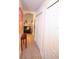Hallway with white closets and tile floor, featuring artwork at 2019 Jaffa Ct, Clermont, FL 34714