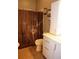 Clean bathroom with brown shower curtain and white vanity at 2019 Jaffa Ct, Clermont, FL 34714