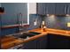Modern kitchen with a farmhouse sink and wood countertops at 2019 Jaffa Ct, Clermont, FL 34714