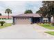 Well-maintained home exterior with a two-car garage and landscaping at 2019 Jaffa Ct, Clermont, FL 34714