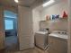 Laundry room with washer, dryer, and storage shelves at 13880 Arclid St, Orlando, FL 32832