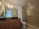 Bathroom with shower, vanity, and granite countertop at 13880 Arclid St, Orlando, FL 32832