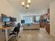 Living room with open floor plan, modern furniture, and home office setup at 13880 Arclid St, Orlando, FL 32832