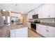 Modern kitchen island with granite countertop and gold faucet at 2370 Brassie Ct, Winter Haven, FL 33884