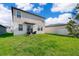 Large grassy backyard with patio and partial house view at 2370 Brassie Ct, Winter Haven, FL 33884