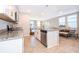 Open concept kitchen with white cabinets and stainless steel appliances at 2370 Brassie Ct, Winter Haven, FL 33884