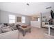 Bonus room features a sectional sofa, a coffee table, and a home office space at 2370 Brassie Ct, Winter Haven, FL 33884