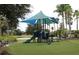 Community playground with shade structure, playset, and benches at 401 Cabello Dr, Davenport, FL 33837
