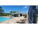 Community pool and bath house with patio and lounge chairs at 4367 White Pine Ave # 4, Orlando, FL 32811