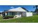 Exterior view of a light gray house with white trim and a neatly landscaped yard at 4367 White Pine Ave # 4, Orlando, FL 32811
