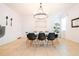 Bright dining room with chandelier, large table, and black chairs at 2669 Santosh Cv, Kissimmee, FL 34746
