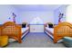 Charming bedroom with twin beds and a whimsical Disney theme at 2669 Santosh Cv, Kissimmee, FL 34746