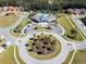 Community center with circular driveway and landscaping at 2669 Santosh Cv, Kissimmee, FL 34746