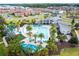Aerial view of community pool, landscaping, and homes at 2669 Santosh Cv, Kissimmee, FL 34746