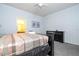 Cozy bedroom with a queen bed and decorative wall paneling at 2669 Santosh Cv, Kissimmee, FL 34746
