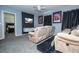 Home theater room with large TV, comfortable seating, and movie posters at 2669 Santosh Cv, Kissimmee, FL 34746