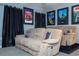 Home theater with reclining sofas, movie posters, and dark curtains at 2669 Santosh Cv, Kissimmee, FL 34746