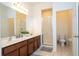 Double vanity bathroom with a shower and modern finishes at 2669 Santosh Cv, Kissimmee, FL 34746