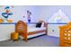 bedroom with twin beds, Disney decor, and ample floor space at 2669 Santosh Cv, Kissimmee, FL 34746