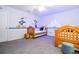 bedroom with two twin beds, Disney-themed wall decals, and grey carpet at 2669 Santosh Cv, Kissimmee, FL 34746