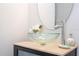 Modern powder room featuring a glass sink and elegant mirror at 2669 Santosh Cv, Kissimmee, FL 34746