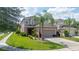 Two-story house with a garage and landscaping at 2669 Santosh Cv, Kissimmee, FL 34746