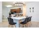 Bright dining area with a kitchen view and modern chandelier at 2669 Santosh Cv, Kissimmee, FL 34746