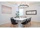 Elegant dining room featuring a white table and black chairs at 2669 Santosh Cv, Kissimmee, FL 34746