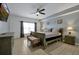 Main bedroom with plush bed, ceiling fan, and dresser at 112 Paloma Dr, Davenport, FL 33837