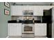 White kitchen cabinets, stainless steel appliances, and granite countertops at 112 Paloma Dr, Davenport, FL 33837