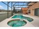 Enjoy this refreshing pool and spa with a covered patio at 112 Paloma Dr, Davenport, FL 33837