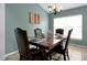 Dining room with wooden table and four leather chairs at 112 Paloma Dr, Davenport, FL 33837