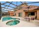 Inviting pool area with spa, patio furniture, and covered patio at 112 Paloma Dr, Davenport, FL 33837