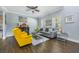 Living room with hardwood floors, gray sofa and yellow armchairs at 6115 Sunset Isle Dr, Winter Garden, FL 34787