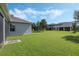 Large backyard with grassy area and partial home view at 6115 Sunset Isle Dr, Winter Garden, FL 34787