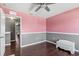 Well-lit bedroom with wood floors, ceiling fan, and access to hallway at 205 Hamlet Rd, Davenport, FL 33837